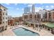 Community outdoor pool with lounge seating, landscaping, and views of the surrounding buildings at 300 W 5Th W St # 407, Charlotte, NC 28202