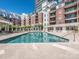 Community outdoor pool with lounge seating, landscaping, and views of the surrounding building at 300 W 5Th W St # 407, Charlotte, NC 28202