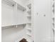 White shelving system in a spacious walk-in closet, offering ample storage and organization options at 300 W 5Th W St # 407, Charlotte, NC 28202