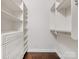 Bright walk-in closet featuring built-in shelving, drawers, and hanging rods for optimal storage at 300 W 5Th W St # 407, Charlotte, NC 28202