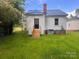 Exterior home view showcasing a well-maintained yard, wooden staircase, and a metal roof at 317 Kings Mountain St, York, SC 29745