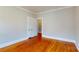 A clean and inviting bedroom featuring hardwood floors, crown molding, and a neutral color palette at 317 Kings Mountain St, York, SC 29745