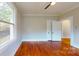 Bedroom featuring hardwood floors, a window and doorway with white trim at 317 Kings Mountain St, York, SC 29745