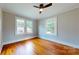 Bright bedroom featuring gleaming hardwood floors, two windows and ceiling fan at 317 Kings Mountain St, York, SC 29745