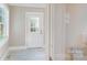 Mud room featuring white tile floor, back door and a partial view of the kitchen at 317 Kings Mountain St, York, SC 29745