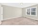 Bright bedroom with neutral tones, carpeted floor, and a large window providing natural light at 340 Vernon Ln, Statesville, NC 28677