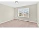 Bedroom with neutral tones, carpeted floor, and a window, offering a cozy and inviting space at 340 Vernon Ln, Statesville, NC 28677