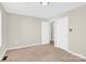 Bedroom featuring neutral tones, carpeted floor, and multiple doors, offering access and natural light at 340 Vernon Ln, Statesville, NC 28677