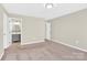 Spacious main bedroom with carpet, neutral walls, and an en-suite bathroom for added privacy and convenience at 340 Vernon Ln, Statesville, NC 28677