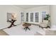 Bright living room featuring light wood floors, french doors, and neutral furniture at 3615 Wild Rose Ct, Matthews, NC 28104