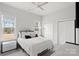 Comfortable bedroom with large windows, neutral tones, and a ceiling fan at 4034 Sagemont Nw Dr, Concord, NC 28027
