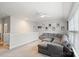 Open-concept living room with comfortable gray sofa and view to the outside at 4034 Sagemont Nw Dr, Concord, NC 28027