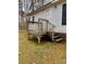 The side entrance features a wood deck and steps, providing access to the home at 410 Johnstone Rd, Cleveland, NC 27013