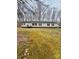 A single-story home with a large front yard covered in moss and pine needles surrounded by a forest backdrop at 410 Johnstone Rd, Cleveland, NC 27013