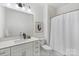 Bright bathroom featuring a white vanity with modern fixtures and a shower with a stylish curtain at 5007 Nimes Rd # 28, Charlotte, NC 28208