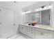 Bright bathroom featuring double sinks, modern fixtures, white marble floors, and a large frameless mirror at 5007 Nimes Rd # 28, Charlotte, NC 28208