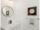 Half bathroom featuring a modern sink, round mirror and unique artwork at 5007 Nimes Rd # 28, Charlotte, NC 28208