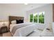 Calm bedroom with large window, neutral color palette, and modern furnishings at 5007 Nimes Rd # 28, Charlotte, NC 28208