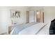 Bright bedroom featuring a large bed, a window with natural light, and views into the bathroom at 5007 Nimes Rd # 28, Charlotte, NC 28208