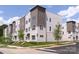 Modern townhome exterior showcasing neutral tones, brick accents, and well-manicured landscaping at 5007 Nimes Rd # 28, Charlotte, NC 28208