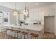 Well-lit kitchen showcasing a center island, breakfast bar, and modern white cabinets at 5007 Nimes Rd # 28, Charlotte, NC 28208