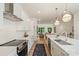 Contemporary kitchen with white cabinetry, quartz countertops, and seamless flow to living areas at 5007 Nimes Rd # 28, Charlotte, NC 28208