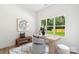 Bright office space featuring desk, bench, modern decor, and a large window with a view of a green yard at 5007 Nimes Rd # 28, Charlotte, NC 28208