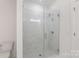 Bright bathroom featuring a glass shower with modern fixtures and white marble tile at 5007 Nimes Rd # 28, Charlotte, NC 28208
