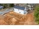 Aerial view of a new construction home featuring white siding and a partially excavated backyard at 504 Sharpe St, Mooresville, NC 28115