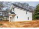 Side view of a new construction home featuring white siding, dark roofing, and an attached garage at 504 Sharpe St, Mooresville, NC 28115