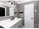 Renovated bathroom featuring gray vanity, marble countertop, and a large mirror at 5060 Post Oak Ln, Rock Hill, SC 29732