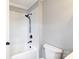 Modern bathroom with white tiled walls, a deep soaking tub, and black fixtures at 5060 Post Oak Ln, Rock Hill, SC 29732