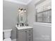 Bathroom with updated vanity, framed round mirror, and modern lighting at 5060 Post Oak Ln, Rock Hill, SC 29732