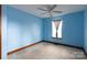 Bedroom with a window, wood trim, carpeted flooring, and ceiling fan at 5060 Post Oak Ln, Rock Hill, SC 29732