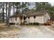 Charming ranch-style home with light siding, stone accents, mature trees, and inviting front porch at 5060 Post Oak Ln, Rock Hill, SC 29732