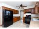 Well-lit kitchen with wooden cabinets, tile floors, and modern black appliances at 5060 Post Oak Ln, Rock Hill, SC 29732