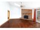 Spacious living room showcases hardwood floors, brick fireplace, and modern lighting fixture at 5060 Post Oak Ln, Rock Hill, SC 29732