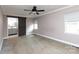 Large main bedroom offers neutral carpet, a ceiling fan, and bathroom access via sliding barn door at 5060 Post Oak Ln, Rock Hill, SC 29732
