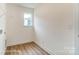 New laundry room with hardwood floors and window for natural light at 5116 Heathland Dr # 76, Charlotte, NC 28215