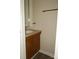 Half bathroom with modern fixtures, a decorative mirror, and an oak-trimmed vanity at 6354 Old Pineville Rd # A, Charlotte, NC 28217