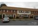 Charming townhome with brick facade, covered entrances, and well-maintained landscaping at 6354 Old Pineville Rd # A, Charlotte, NC 28217