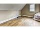 Cozy attic bedroom with hardwood floors and a bright window at 7811 Biddstone Ct, Charlotte, NC 28226