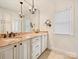 Elegant bathroom featuring dual sinks, granite countertop, and decorative chandeliers at 7811 Biddstone Ct, Charlotte, NC 28226