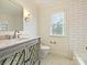 Stylish bathroom with subway tile, marble floors, and a modern vanity, creating a spa-like retreat at 7811 Biddstone Ct, Charlotte, NC 28226