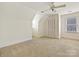 Neutral bedroom with a ceiling fan, a large window, and an access door at 7811 Biddstone Ct, Charlotte, NC 28226