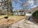 Charming single-story home featuring a well-manicured lawn, a detached garage, and mature trees at 7811 Biddstone Ct, Charlotte, NC 28226