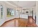 Bright kitchen area featuring hardwood floors, a large window, and stainless steel appliances at 7811 Biddstone Ct, Charlotte, NC 28226