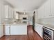 Modern kitchen with white cabinets, granite countertops, stainless steel appliances, and hardwood floors at 7811 Biddstone Ct, Charlotte, NC 28226