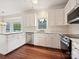Modern kitchen featuring white cabinets, granite countertops, stainless steel appliances, and hardwood floors at 7811 Biddstone Ct, Charlotte, NC 28226