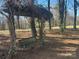 Relaxing backyard with a wooden bench swing and a view of the wooded area at 805 Stack Rd, Monroe, NC 28112